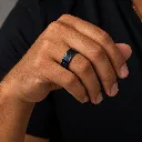 black-ceramic-ring-with-blue-carbon-fiber-inlay-on-hand.webp