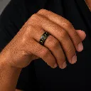black-ceramic-ring-with-yellow-carbon-fiber-inlay-on-hand.webp